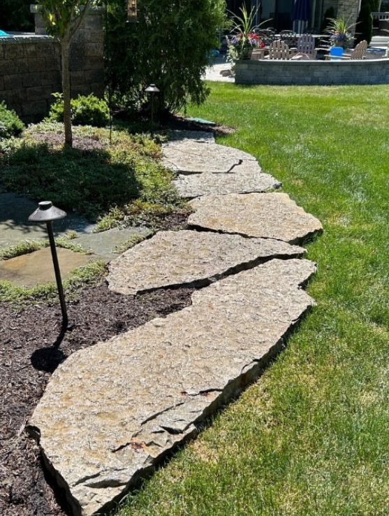Natural stone paver path restored to a warm clean finish after pressure washing